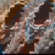 Hand on mug of coffee