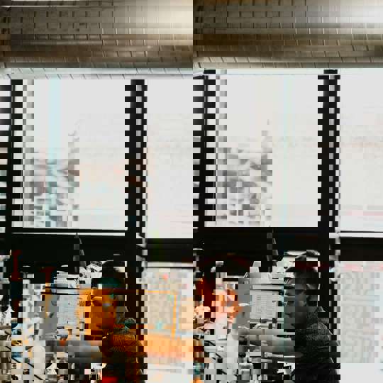 Man Working In Coffee Shop